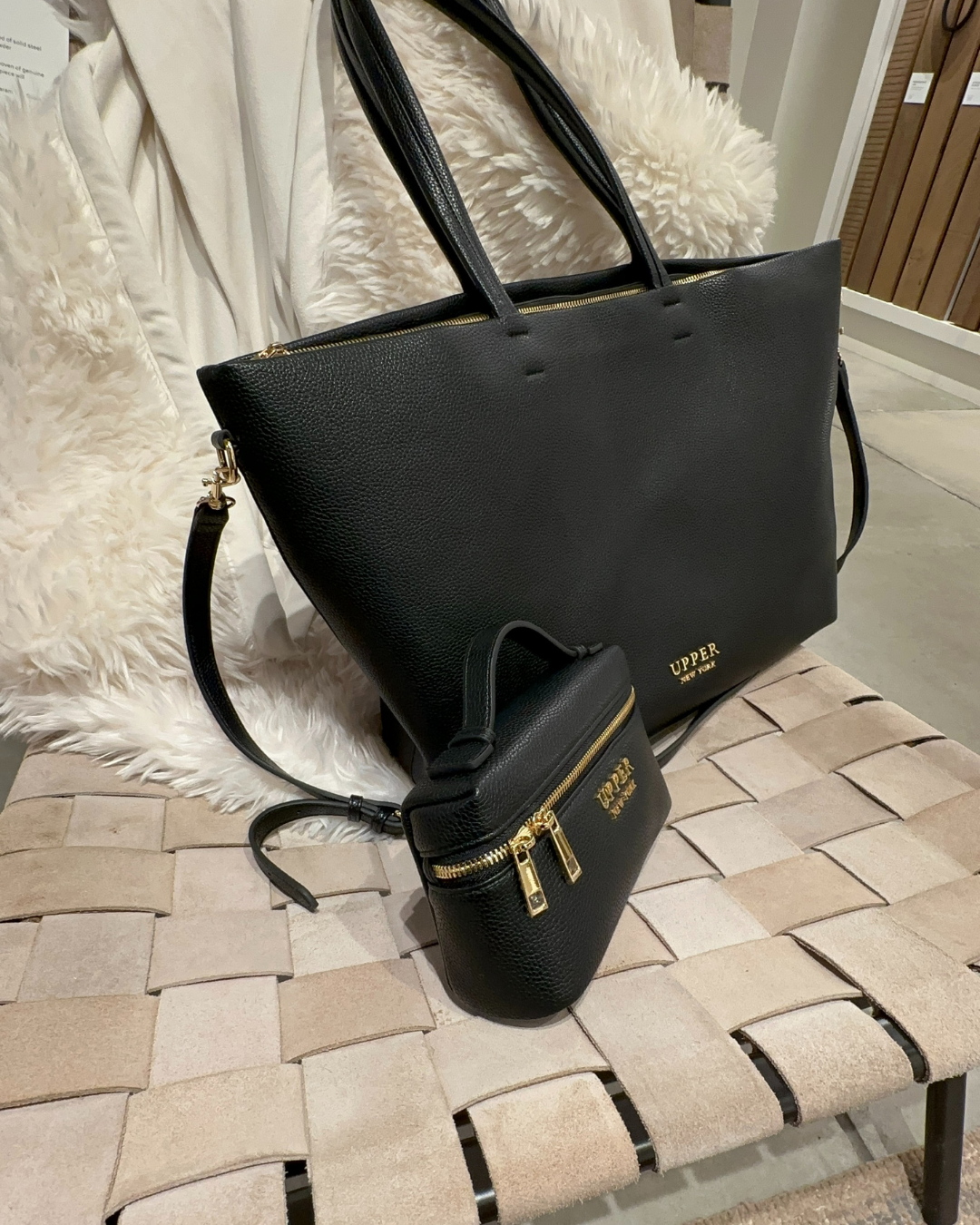 Carry-On Tote and Mini crossbody in black, set on a woven chair