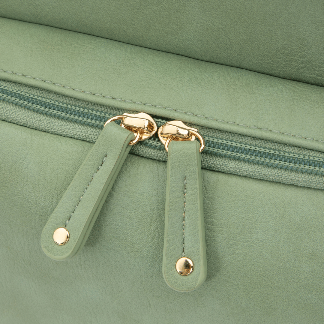 DayFlow everyday backpack for parents in sage green, close-up of the zip pulls