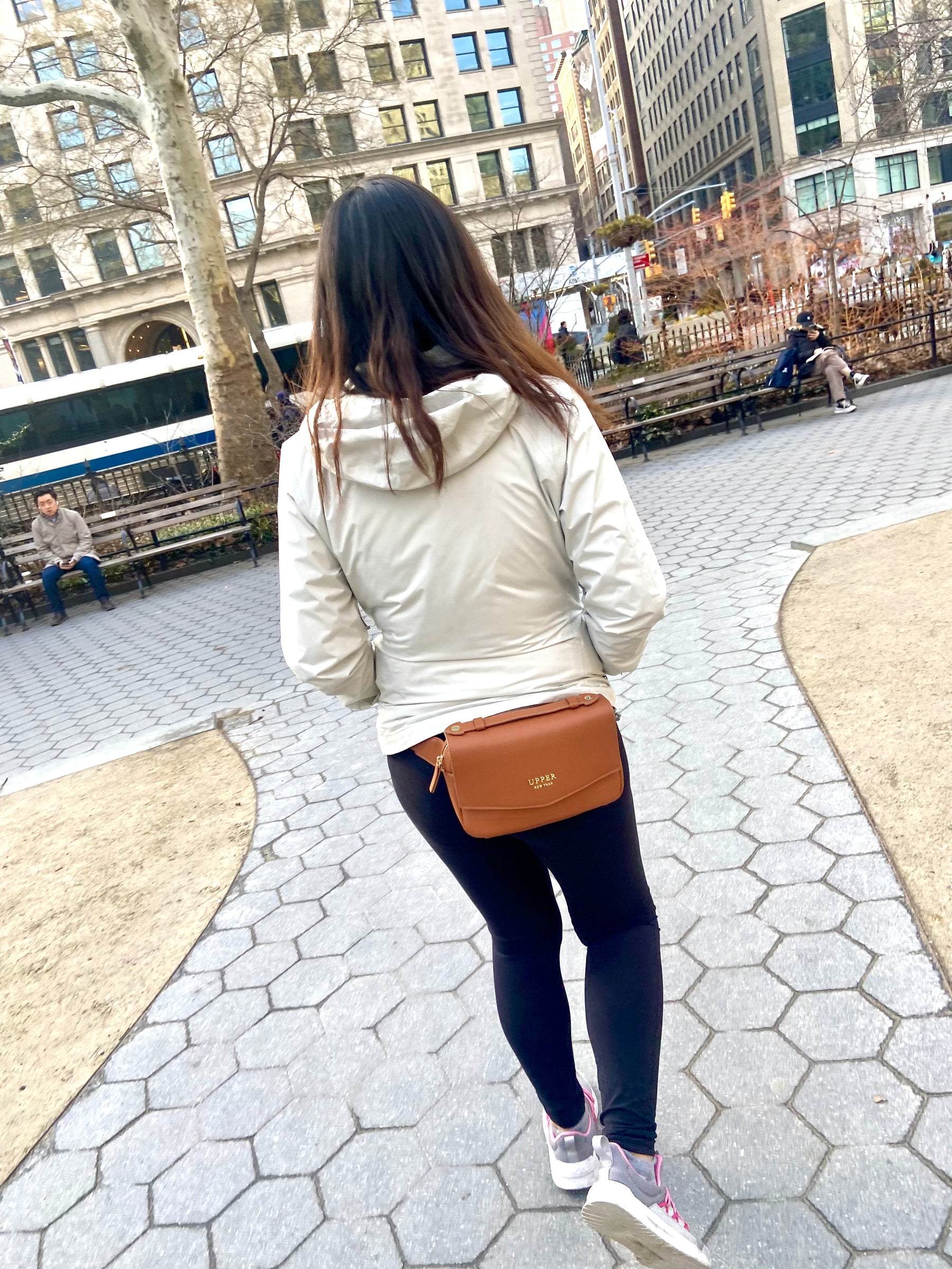 Everyday sling in caramel worn by a mom walking through the park
