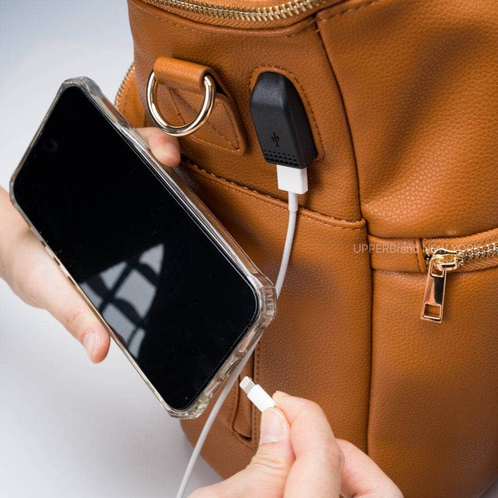 Harvey everyday backpack for parents charging a phone from the side port