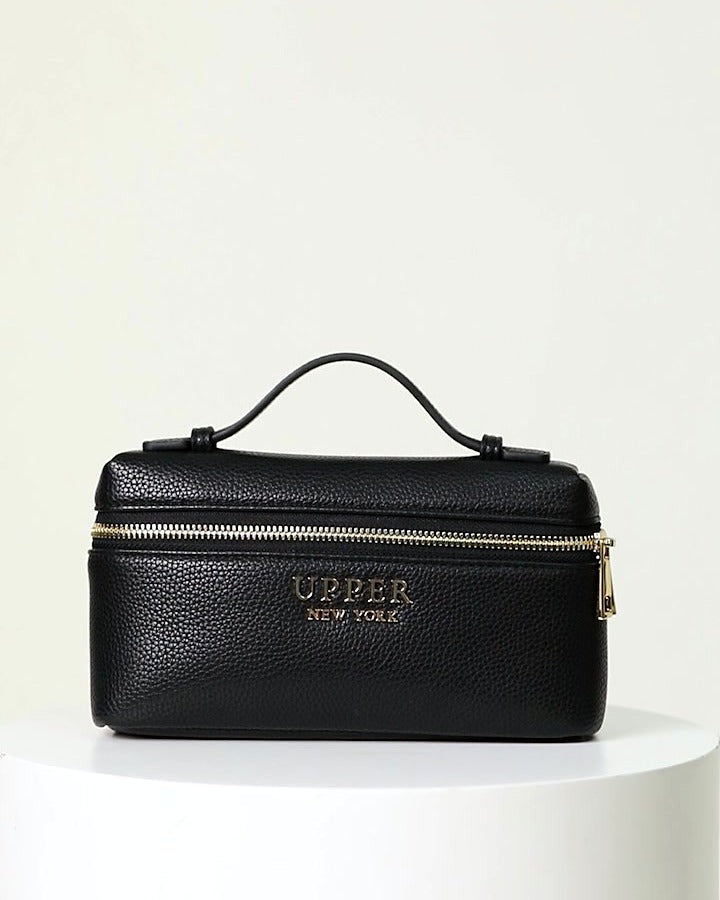 Mini crossbody bag in black pebbled vegan leather with gold zip and top handle
