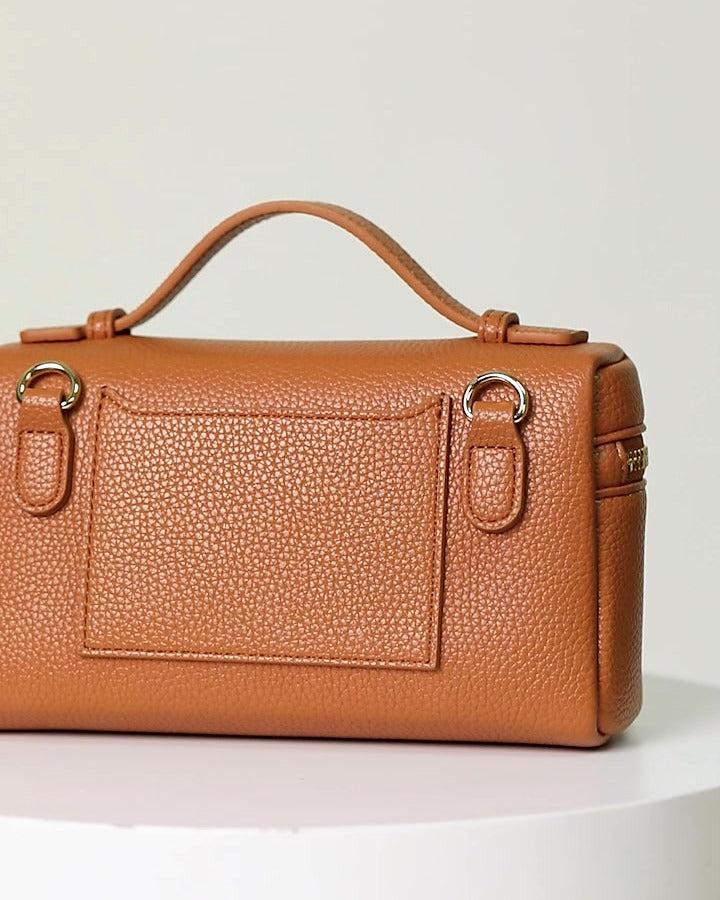 Mini crossbody bag in caramel, back view with slip pocket